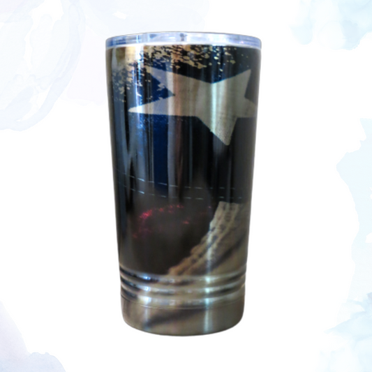 A 16 oz. stainless steel tumbler with a distressed American flag design. This tumbler features a weathered flag print that adds a vintage, patriotic touch. The durable stainless steel construction keeps beverages at the desired temperature for longer. Perfect for showing American pride while enjoying drinks on the go. Ideal for both hot and cold beverages.