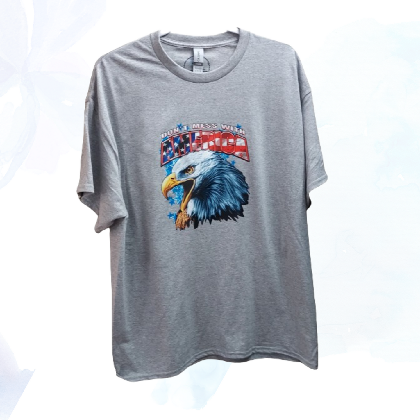 Show your patriotic pride with our "Don't Mess With America" t-shirt! Crafted from a premium 50/50 blend of cotton and polyester for unmatched comfort and durability. The classic gray hue complements the bold eagle head graphic emblazoned across the chest, symbolizing strength, freedom, and resilience.