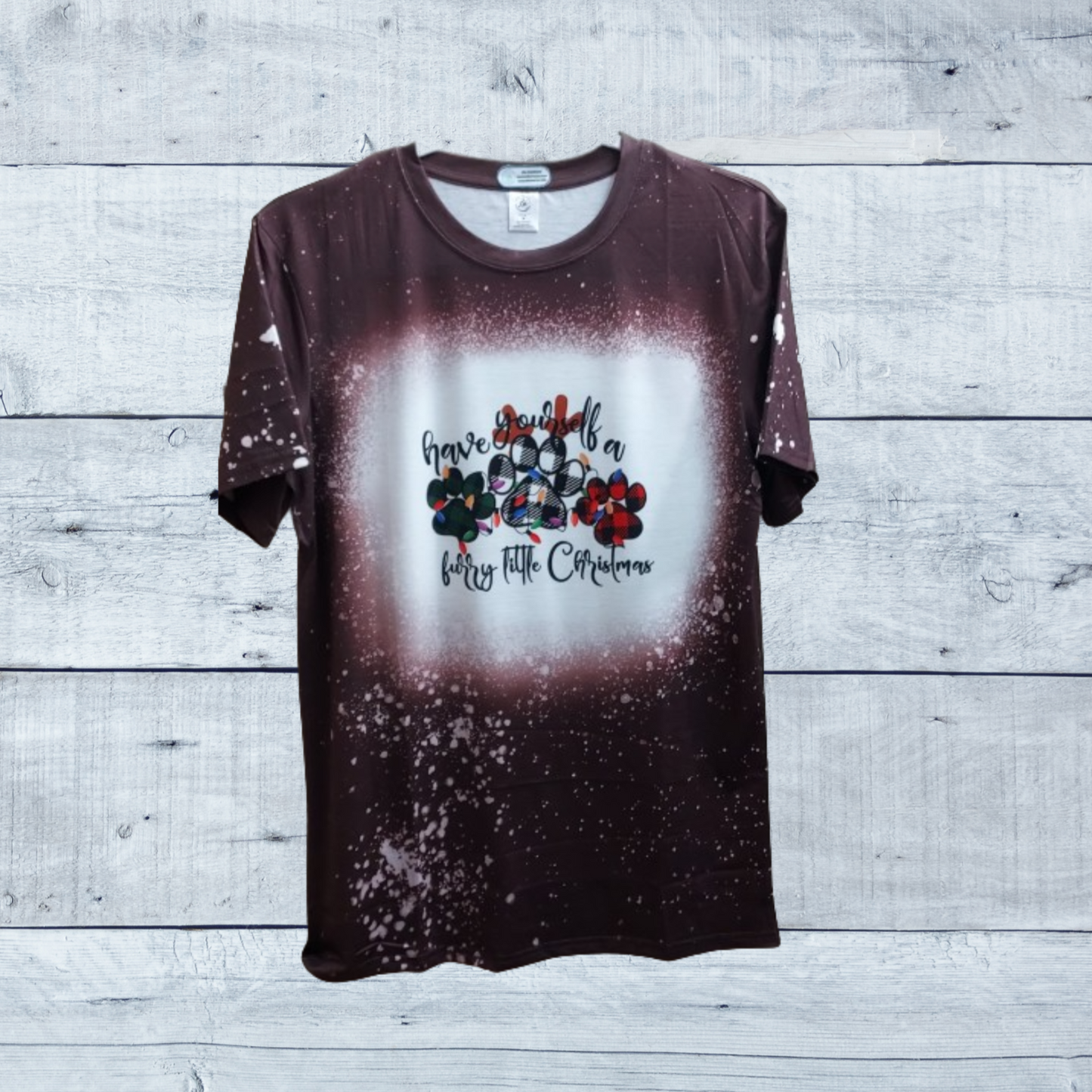 Introducing the "Have Yourself a Furry Little Christmas Brown Faux Bleached Tee," the perfect blend of festive charm and cozy comfort for the holiday season. Crafted with care, this tee combines a stylish brown hue with a faux bleached effect, giving it a unique and vintage-inspired look that stands out.