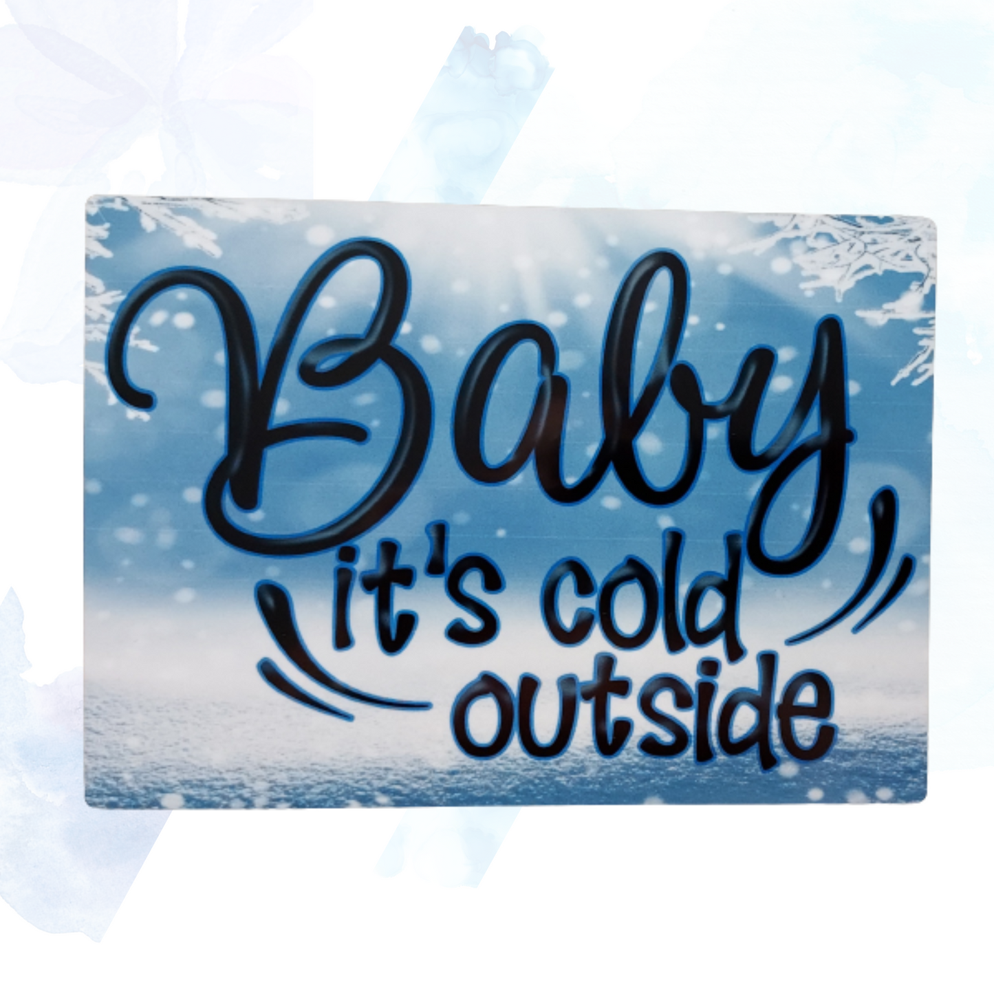 Embrace the charm of winter with this delightful 5" x 7" shelf sitter featuring the timeless phrase "Baby It's Cold Outside". Set against a serene winter background, this piece captures the essence of the season with its softly falling snowflakes, frosted branches, and a hint of cozy warmth.