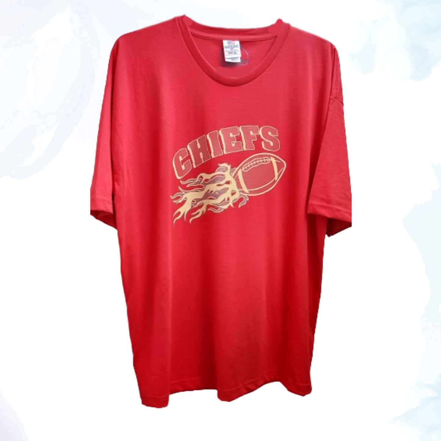 Emblazoned across the front is a bold, flaming football graphic, symbolizing the intensity and spirit of the sport. The striking design is complemented by the iconic Chiefs logo, proudly displayed to showcase your allegiance to one of the NFL's most storied franchises. Made from high-quality cotton blend fabric, our t-shirt ensures comfort throughout the day, whether you're cheering from the stands or relaxing with friends.