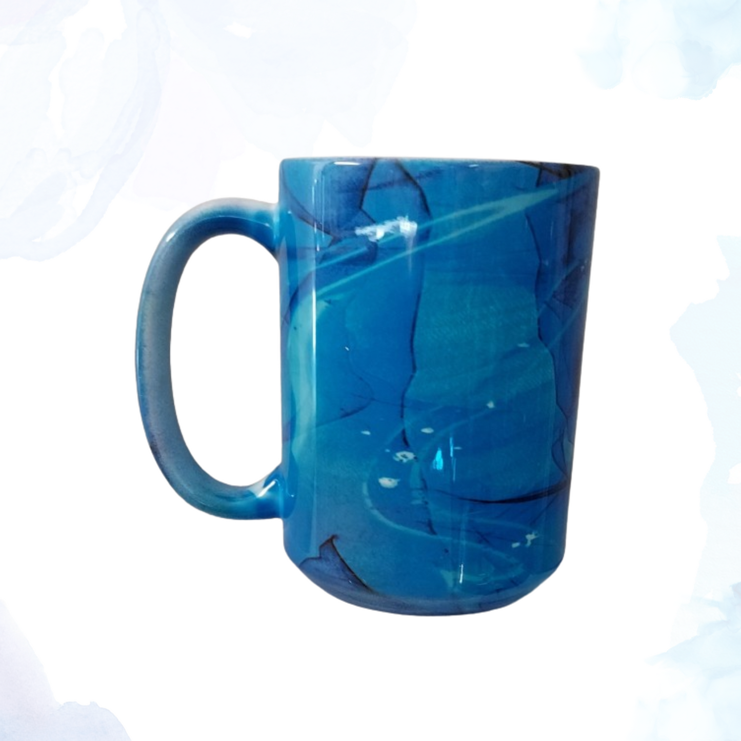 Experience your morning cup of coffee or tea like never before with our 15 oz. Blue Swirl Ceramic Mug! A perfect blend of functionality and artistry. This generously sized mug is ideal for your favorite hot beverages, from coffee and tea to hot chocolate. Crafted from high-quality ceramic, it features a mesmerizing blue swirl design that adds a touch of elegance to your daily routine.