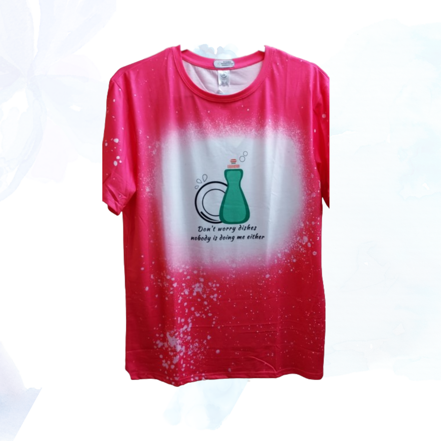 Uncertain about doing the dishes? Don't worry - with this soft, comfy t-shirt you won't have to shell out any sort of effort at all! Our vibrant bright pink faux bleached tee featuring the cheeky "Don't Worry Dishes Nobody Is Doing Me Either" —a must-have for those who appreciate a touch of humor and style in their wardrobe. This tee isn't just about looks; it's crafted for comfort and durability, using high-quality materials that ensure a soft feel against your skin and long-lasting wear