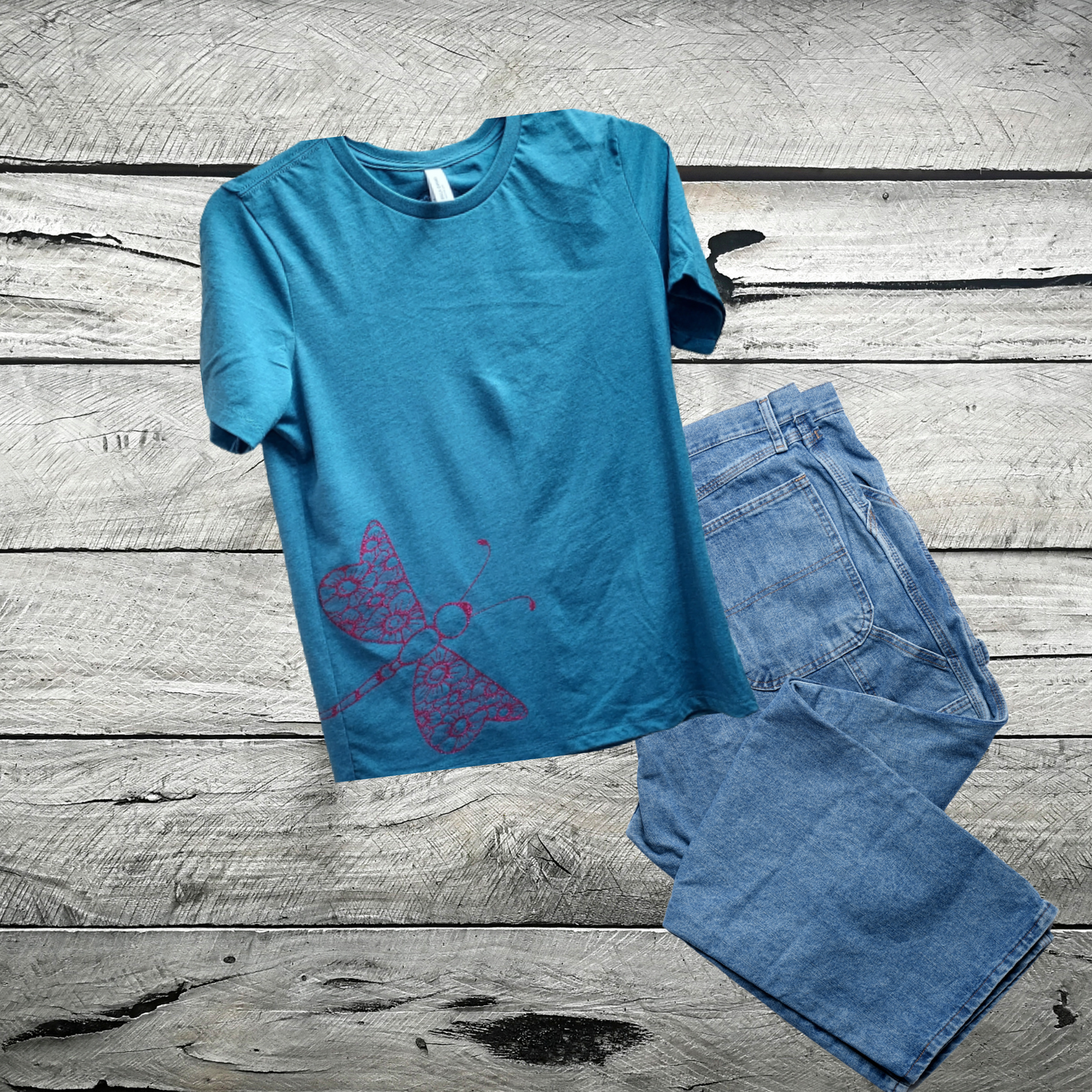 Our enchanting Deep Pink Sparkly Dragonfly on Heather Deep Teal Tee, where nature meets shimmering style. Embrace the allure of the dragonfly, symbolizing transformation and grace, beautifully captured in deep pink hues that sparkle with every move.