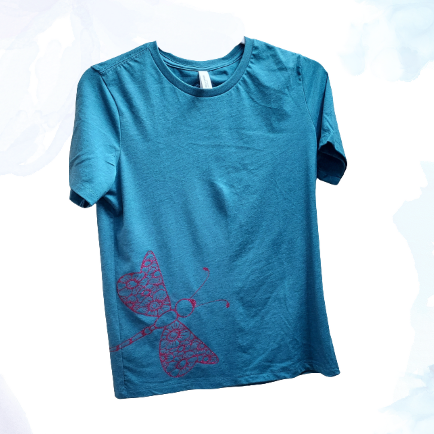 Our enchanting Deep Pink Sparkly Dragonfly on Heather Deep Teal Tee, where nature meets shimmering style. Embrace the allure of the dragonfly, symbolizing transformation and grace, beautifully captured in deep pink hues that sparkle with every move.