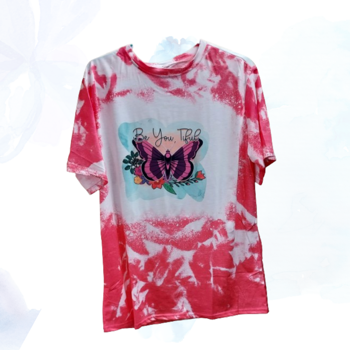 Embrace your unique beauty with our "Be You Tiful Butterfly" faux bleached t-shirt, available in serene shades of pink or lavender.  Each shirt is a canvas of creativity, featuring a meticulously crafted faux bleach effect that gives it a distinct, one-of-a-kind appearance. The design centers around a graceful butterfly, symbolizing transformation and individuality, surrounded by delicate swirls and patterns that evoke a sense of whimsy and freedom.