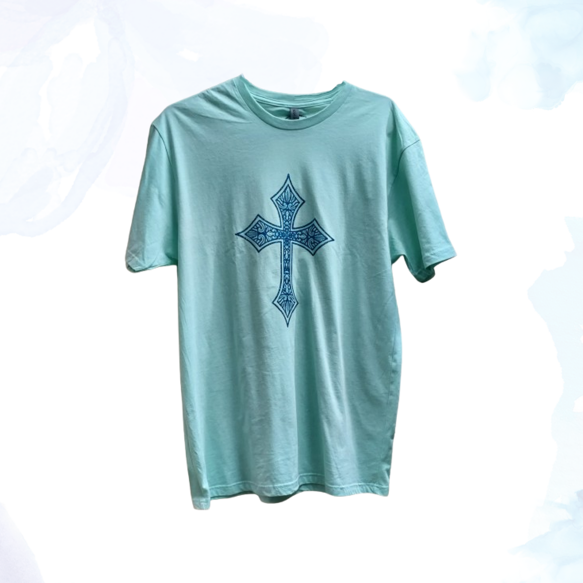 Introducing our Mint Green T-shirt with a Blue Glittery Cross, where comfort meets style in a dazzling blend.  Crafted from premium cotton, this t-shirt ensures a soft and breathable feel, perfect for everyday wear.  The standout feature of this shirt is its eye-catching blue glittery cross design, meticulously placed on the front. The shimmering blue adds a touch of elegance and flair, making this t-shirt ideal for both casual outings and special occasions.