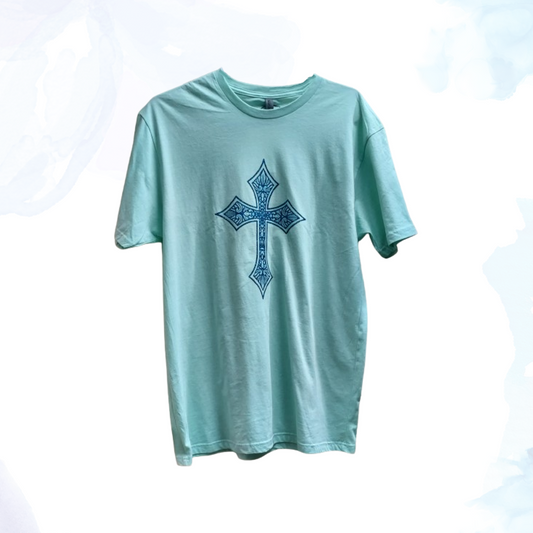 Introducing our Mint Green T-shirt with a Blue Glittery Cross, where comfort meets style in a dazzling blend.  Crafted from premium cotton, this t-shirt ensures a soft and breathable feel, perfect for everyday wear.  The standout feature of this shirt is its eye-catching blue glittery cross design, meticulously placed on the front. The shimmering blue adds a touch of elegance and flair, making this t-shirt ideal for both casual outings and special occasions.