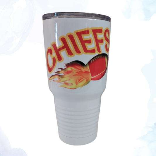 A 30 oz. stainless steel white tumbler featuring a Chiefs blazing football design. This tumbler showcases the Kansas City Chiefs football team logo and colors with a dynamic, fiery aesthetic. Made from durable stainless steel, it keeps beverages hot or cold for extended periods. Perfect for Chiefs fans to enjoy their drinks while proudly displaying their team allegiance.