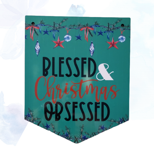 Embrace the spirit of the season with our enchanting Blessed &amp; Christmas Obsessed Pendant Wall Hanger.  This meticulously crafted piece combines festive charm with timeless elegance, making it the perfect addition to your holiday decor.