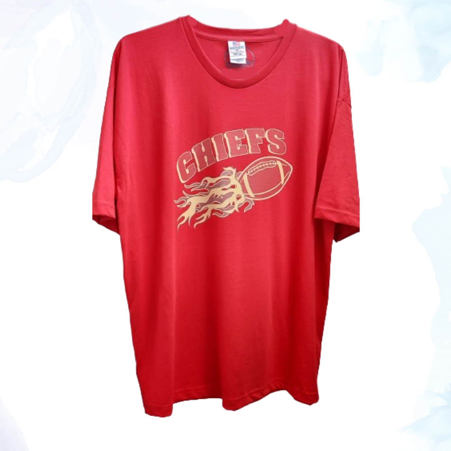 Emblazoned across the front is a bold, flaming football graphic, symbolizing the intensity and spirit of the sport.  The striking design is complemented by the iconic Chiefs logo, proudly displayed to showcase your allegiance to one of the NFL's most storied franchises.  Made from high-quality cotton blend fabric, our t-shirt ensures comfort throughout the day, whether you're cheering from the stands or relaxing with friends.