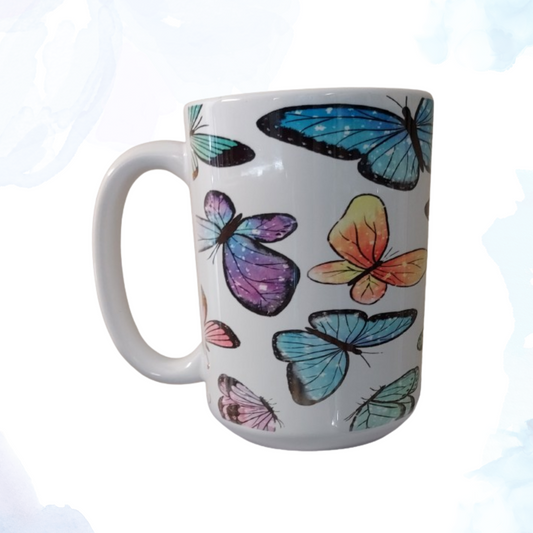 Embrace the beauty of nature with our exquisite 15 oz. Ceramic Butterfly Mug.  This enchanting mug features a captivating design of vibrant butterflies fluttering gracefully across its surface. Each butterfly is intricately detailed, showcasing a spectrum of colors that bring a touch of elegance and whimsy to your morning routine. Crafted from high-quality ceramic, this mug is both durable and stylish, making it perfect for enjoying your favorite hot beverages. 