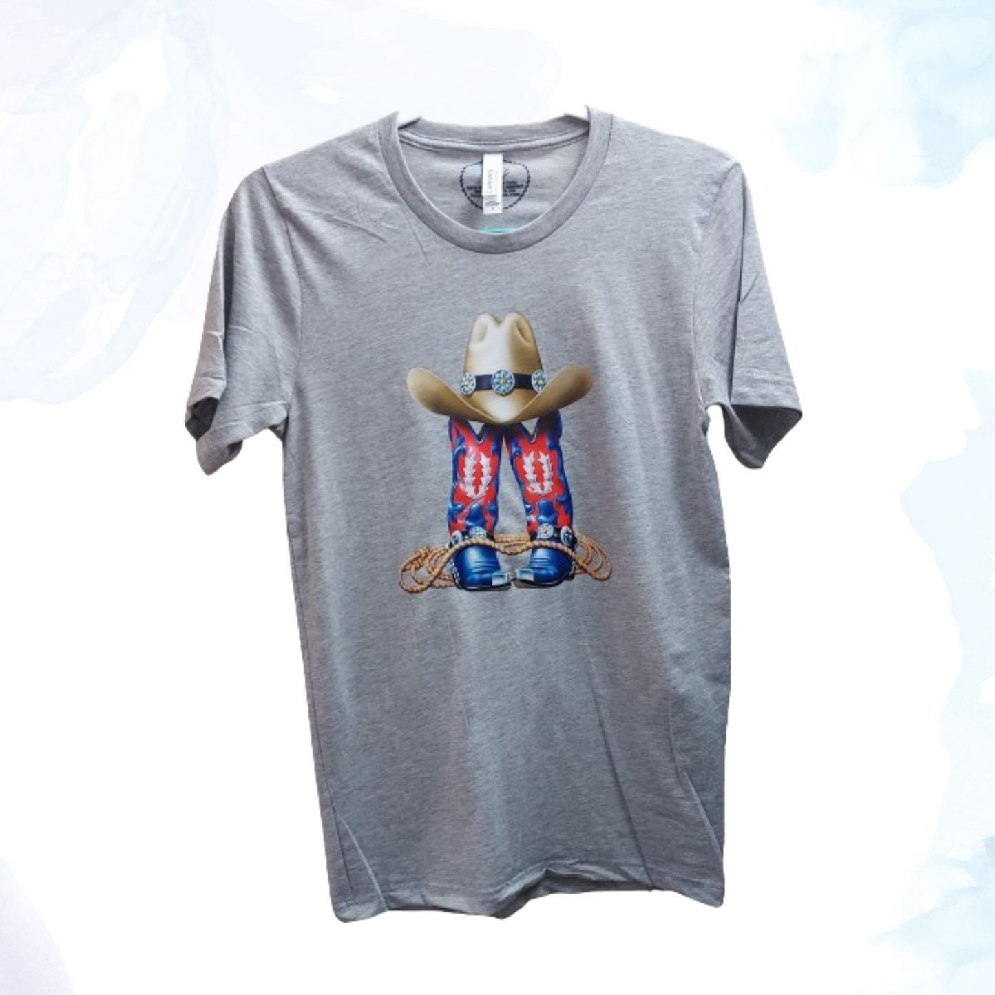 Step into the wild west with our Cowgirls Boots &amp; Hat Gray T-Shirt, a perfect blend of rugged charm and feminine flair. Inspired by the spirit of cowgirls everywhere, this tee celebrates the bold attitude and independent spirit of those who forge their own path.  Emblazoned with a stylish graphic featuring classic cowgirl boots and hat, the design captures the essence of frontier adventure and Western style