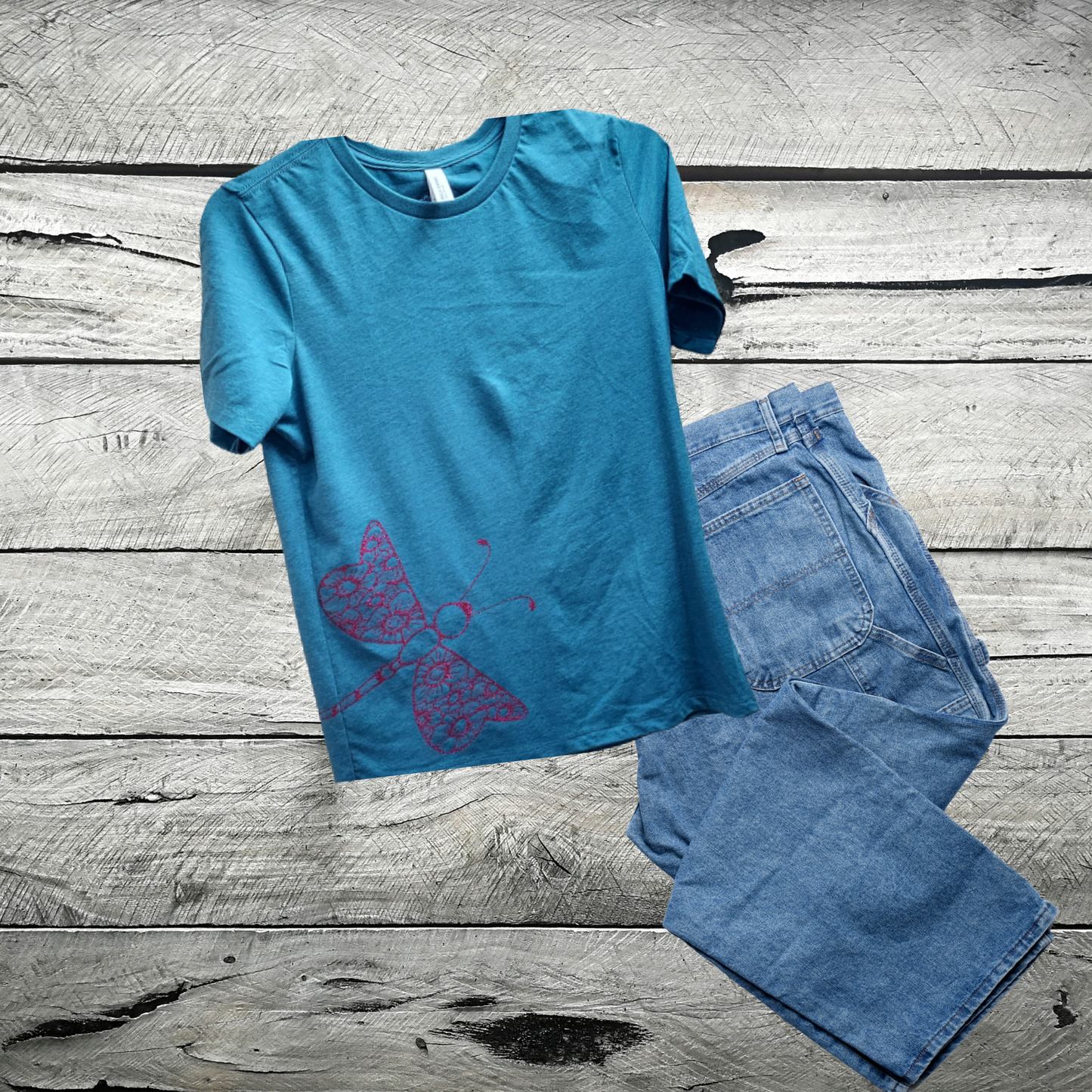 Our enchanting Deep Pink Sparkly Dragonfly on Heather Deep Teal Tee, where nature meets shimmering style.  Embrace the allure of the dragonfly, symbolizing transformation and grace, beautifully captured in deep pink hues that sparkle with every move.