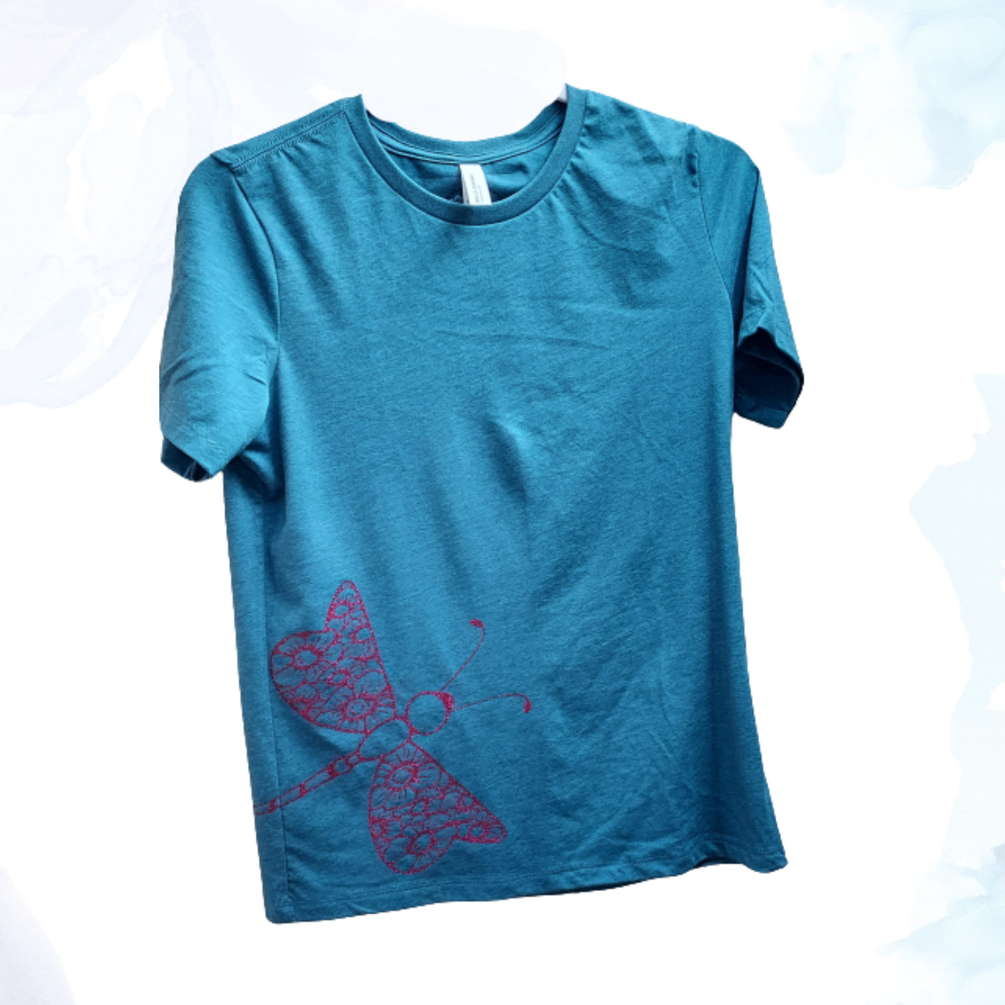 Our enchanting Deep Pink Sparkly Dragonfly on Heather Deep Teal Tee, where nature meets shimmering style.  Embrace the allure of the dragonfly, symbolizing transformation and grace, beautifully captured in deep pink hues that sparkle with every move.